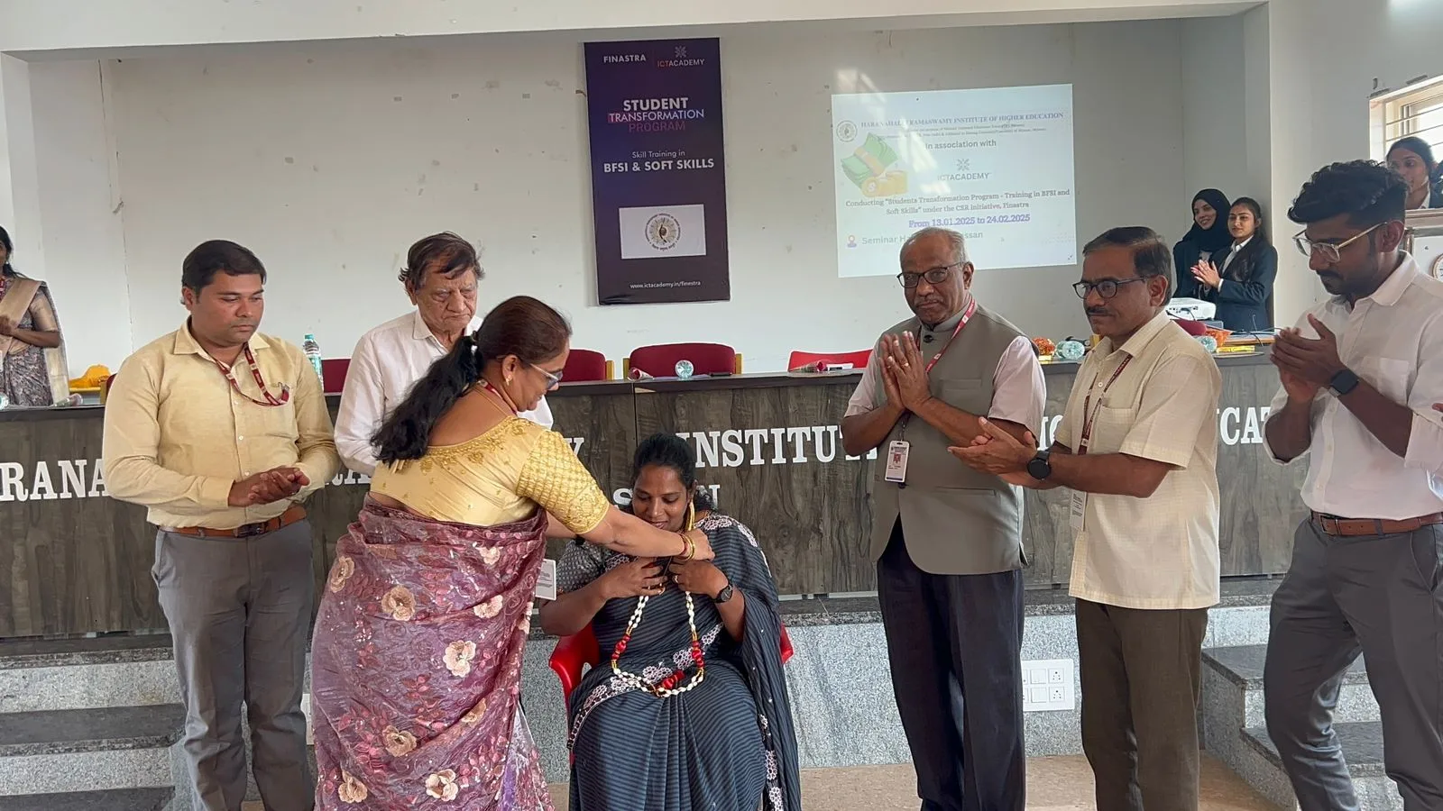 Mrs. Rita Marshall being honored with a garland at the BFSI and Soft Skills program inauguration at HRIHE